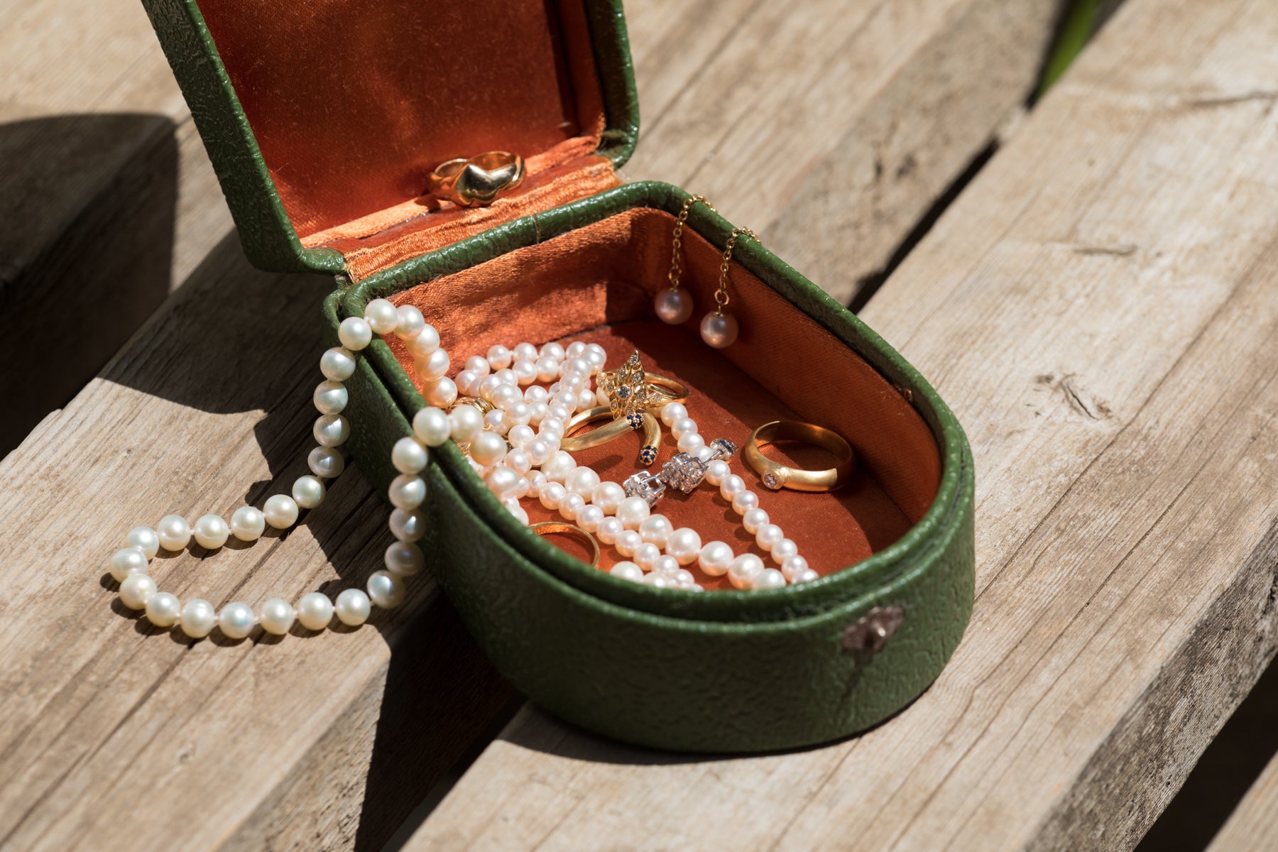 Pearl necklace kept in a jewelry box with a separate compartment for pearls longevityy